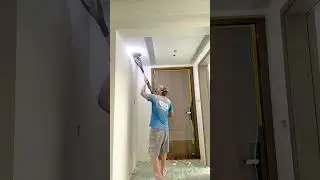smoothing the ceiling using a power sander tool with vacuum dust collector to make surface even flat