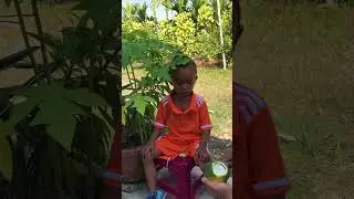 My son picking up orange at home.