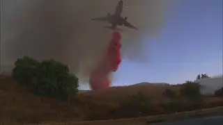 Watch DC-10 jet drop Phos-Chek to control the Anaheim Hills 'Canyon Fire 2' brush fire