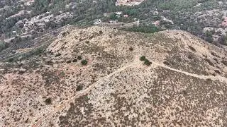 Vast Hillside Trail With Lonely Tree, Barren Hillside From Above With Winding Path And Distant