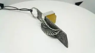The Keeper. Pendant. Steel/Nickel/Copper mokume gane, Sterling silver, Titanium, raw sapphire.