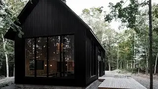 A Black Metal Cottage in Quebec With a Stunning Interior