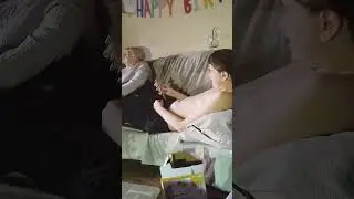 Jackson Walsh on the sofa with a musical instrument