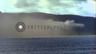 Depth charge explosion at sea and smoke columns rise at a beach during invasion o...HD Stock Footage