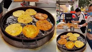 Cooking deep fried pies with meat filling, Chinese street food.