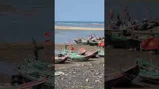 Traditional fishing boats in vietnam at low tide