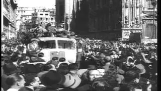 A large number of people cheer as partisans move past them and Fascists open fire...HD Stock Footage