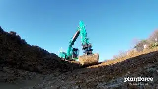 Leica Geo-Systems semi automated GPS Kobelco excavator with SMP tilt rotator digging a swale pond.