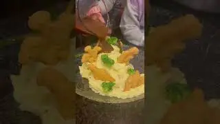 Dinosaur volcano: mashed potatoes, dinosaur chicken nuggets, broccoli, asparagus and gravy.