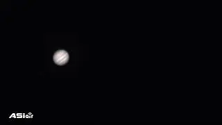 Jupiter with its moon 'Io' transitioning across the surface