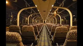 Inside look of a modern railroad passenger car with kitchen and elevator.