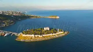 Kusadasi, Turkey. Aerial view of Pigeon Island with its historic castle and causeway. Summer morn...
