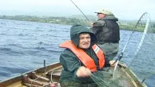 A big salmon is being hooked on Lough Eske, County Donegal, Ireland.