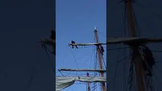 Folding the sail on the Top Gallant