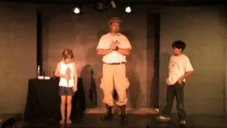 Wildman Phil - Volunteers hold a large lizard