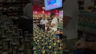 Jason Momoa and Blaine Halvorson sign bottles of their Meili Vodka before meeting Colorado fans