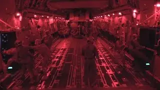 US Military Paratroopers Jump out of a C17 Plane at Night