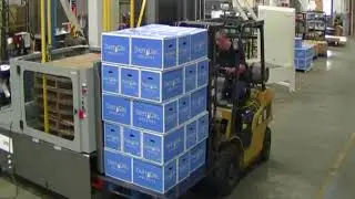 Load Transfer Station (LTS) Transferring Pallet Load from a Wood to CHEP Pallet