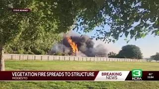 Modesto vegetation fire spreads to structures, officials say