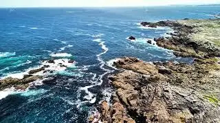 Powerful ocean waves crash on the rugged coastline, creating an aweinspiring scene