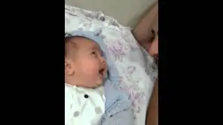 3 months old baby is talking with his father..