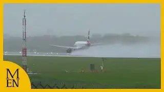 Planes take off at Manchester Airport during wet and windy Storm Amy