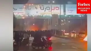 Iranians Set Banner On Fire Amid Massive Anti-Government Protests