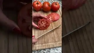 Cutting a tomato with a serrated knife