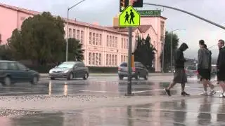Cars splashing puddles on pedestrians
