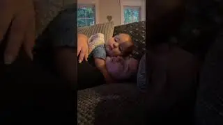 Baby On Top Of Mom Cuddling And Hugging Couch
