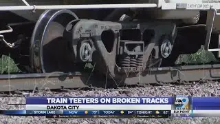 Train teeters on broken tracks