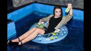 business girl got wet in her clothes in the pool after a deal