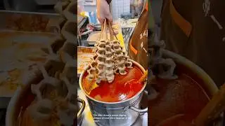 Delicious chinese street food: spicy sausage skewers