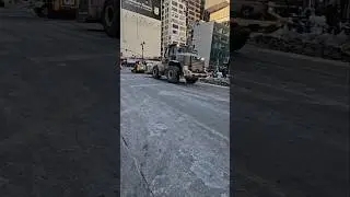 Two Lease DSNY CAT Front End Loaders Passing By On 8th Ave In Midtown, Manhattan, New York City