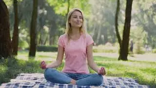 Happy Woman Practices Yoga And Meditates In Lotus Pose Sitting On The Grass Outdoors Free Stock Vide
