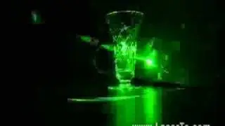 95mw green laser pointer pointing on glass