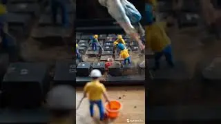 Tiny workers cleaning between the keys of a dirty computer keyboard