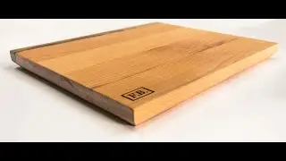 Cutting board made from pear wood with a walnut strip