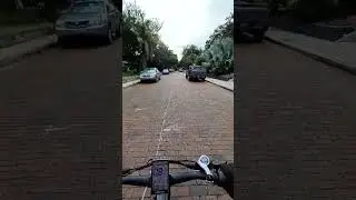 Sirivanh is riding bicycle on brick road in St. Petersburg. Florida