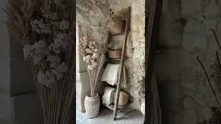 A repurposed wooden ladder leaning against a rustic stone wall (@modernheritagehome