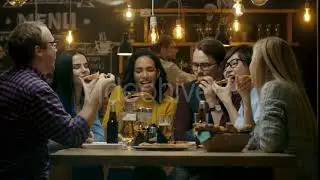 In the Bar/ Restaurant Group of Diverse Young People Eat Slices of Pizza Pie. | Stock Footage -