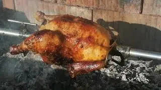 Grillcsirke forgónyárson sütve. Grilled chicken on a spit.