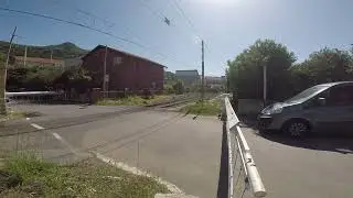 Dual EMU's pass railroad crossing in Cefalu Sicily Italy