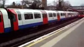 Two Piccadilly line tube trains arrive at Osterley station
