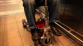 TravelScoot mobility scooter being used in an elevator.