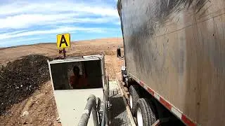 Backing onto the landfill tipper, tipper view.