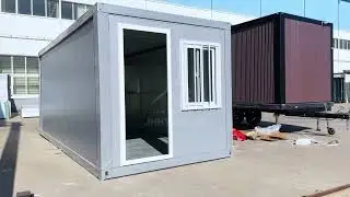 The gray foldable container house features a glass curtain wall and floor-to-ceiling window design.