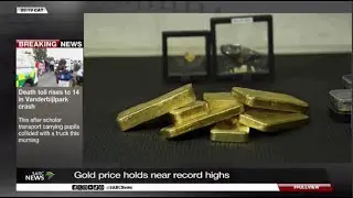 Gold price holds near record highs