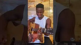 African playing spanish guitar on steel string