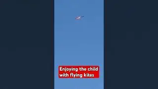 child enjoying with flying different colours of kites #enjoy #kite #enjoy #village #viralvideo